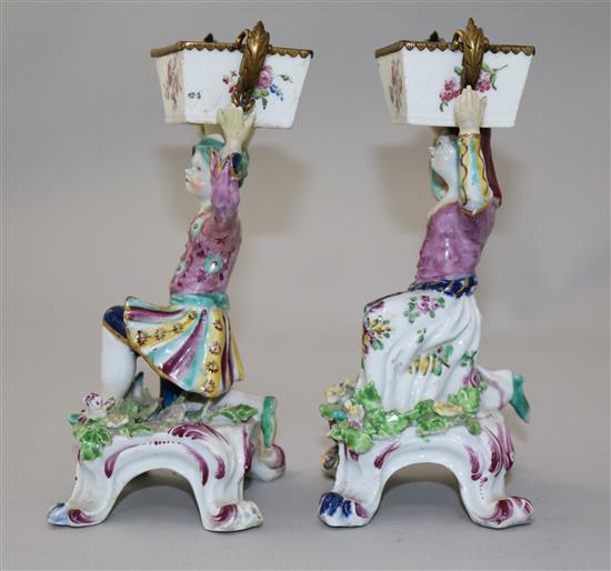 A pair of Bow figural sweetmeat dishes, c.1765-70, height 17cm, restorations